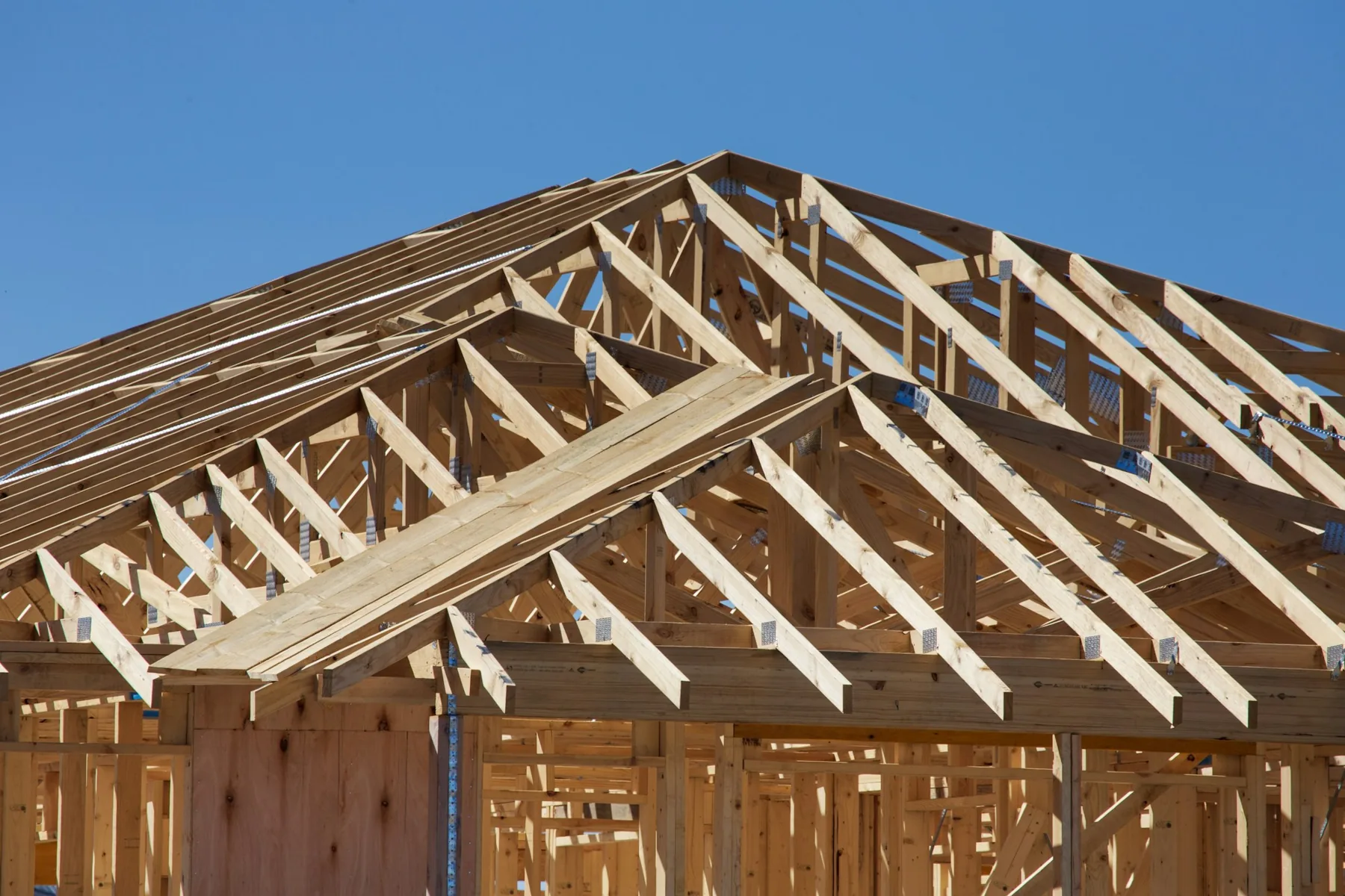 New home under construction with roof trusses set