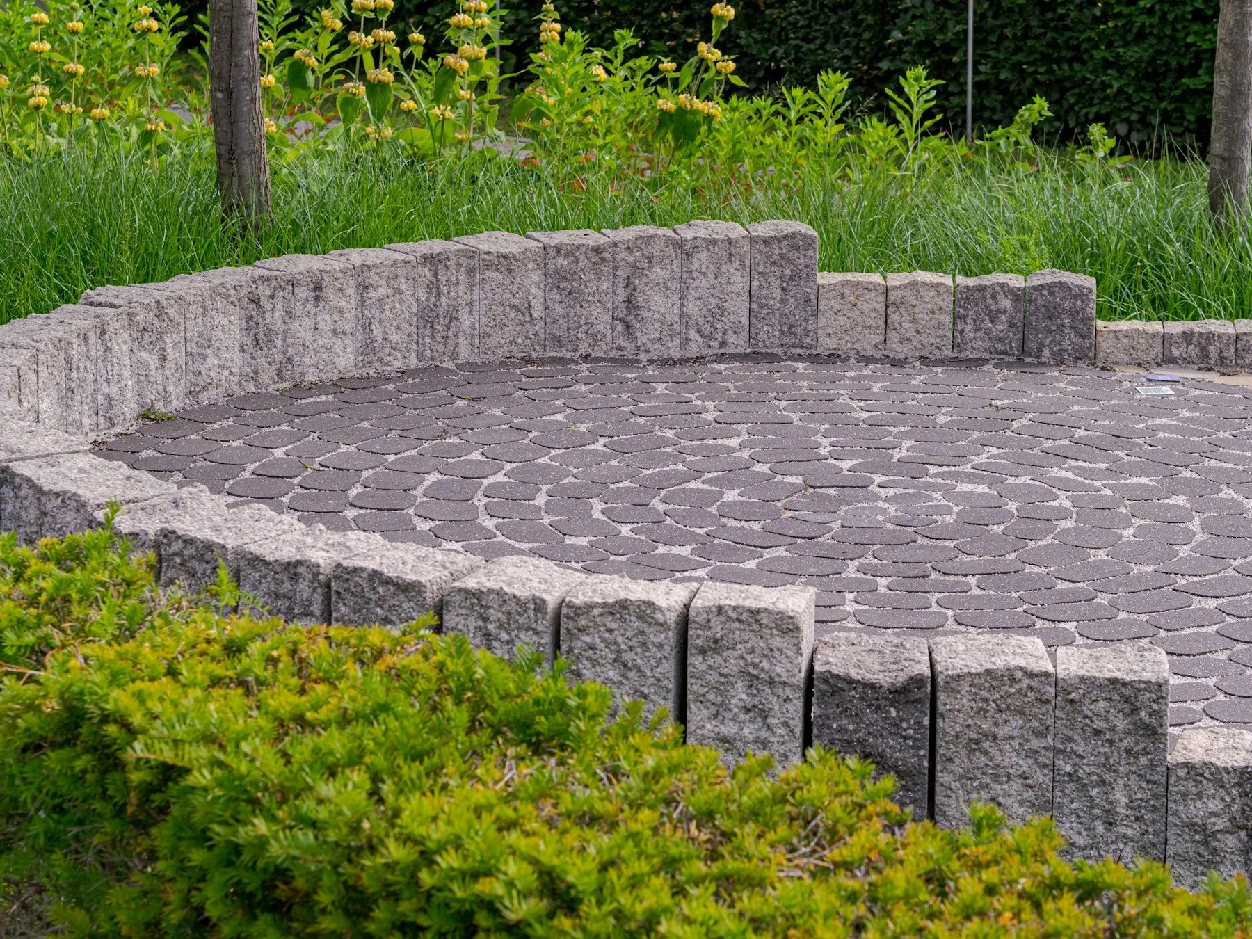 Interlocking concrete pavers laid in a herringbone pattern